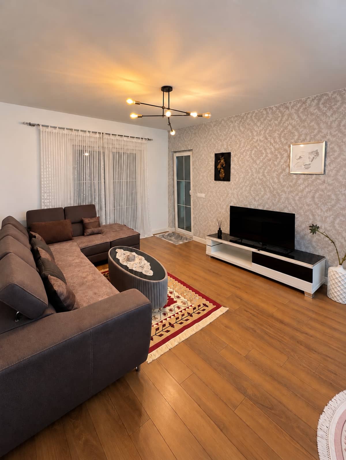 Warm living room with a corner sofa at Albanica Residence